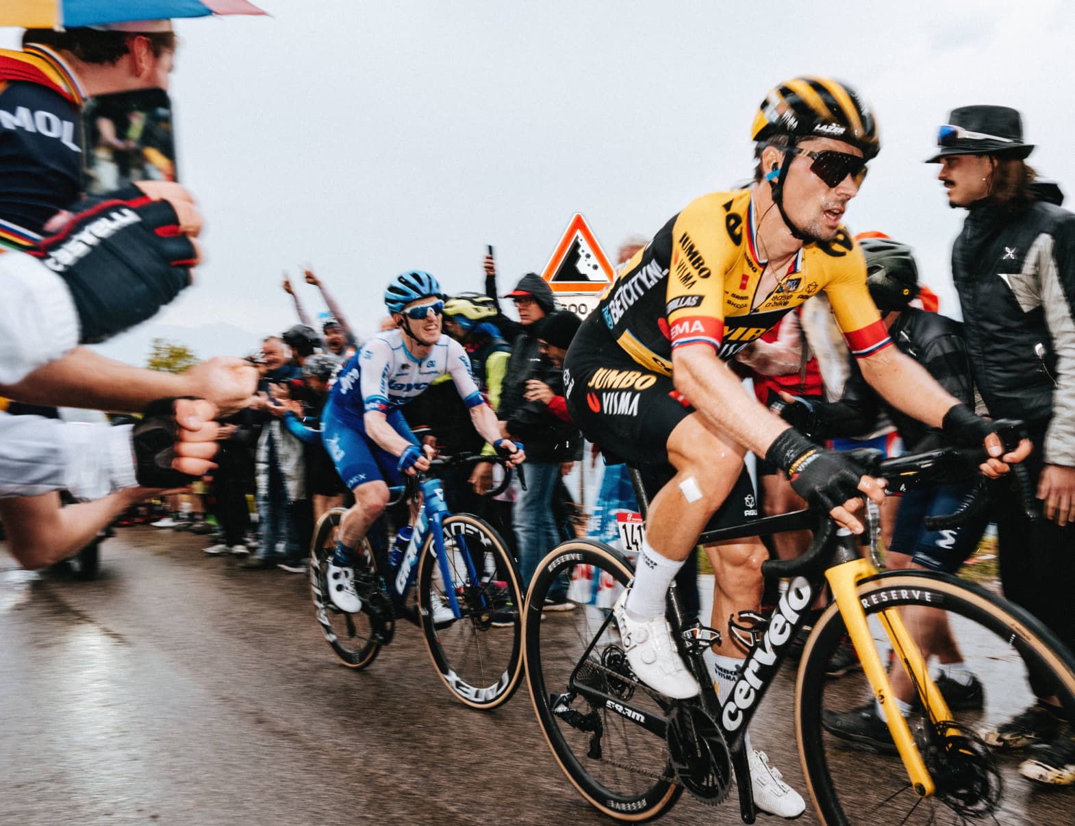 Primož Roglič is pedaling his bike in rainy conditions. He does not look like he’s having a good time.