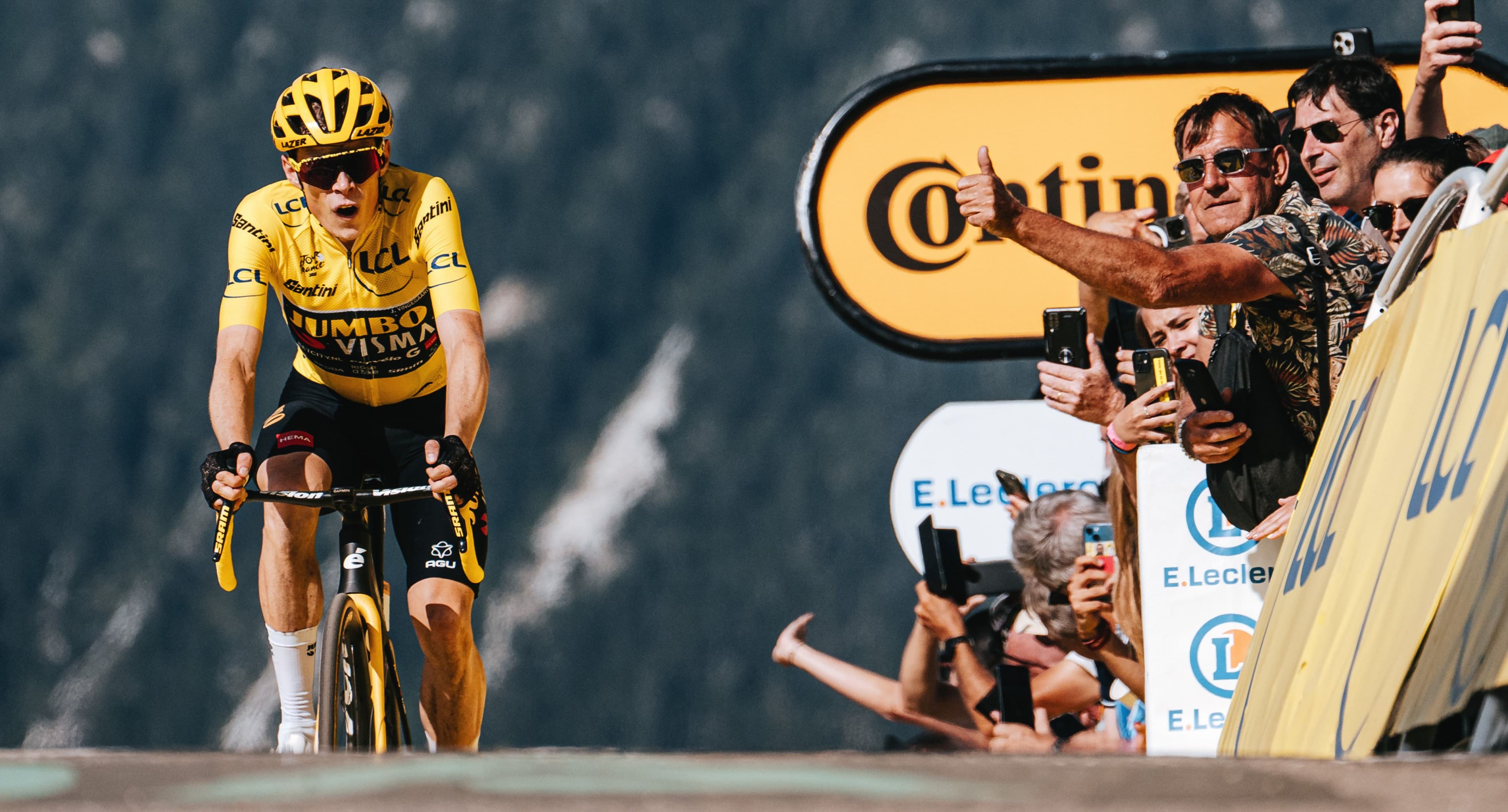 Jonas Vingegaard, wearing the yellow jersey, crests a mountaintop finish on his Cervélo R5.