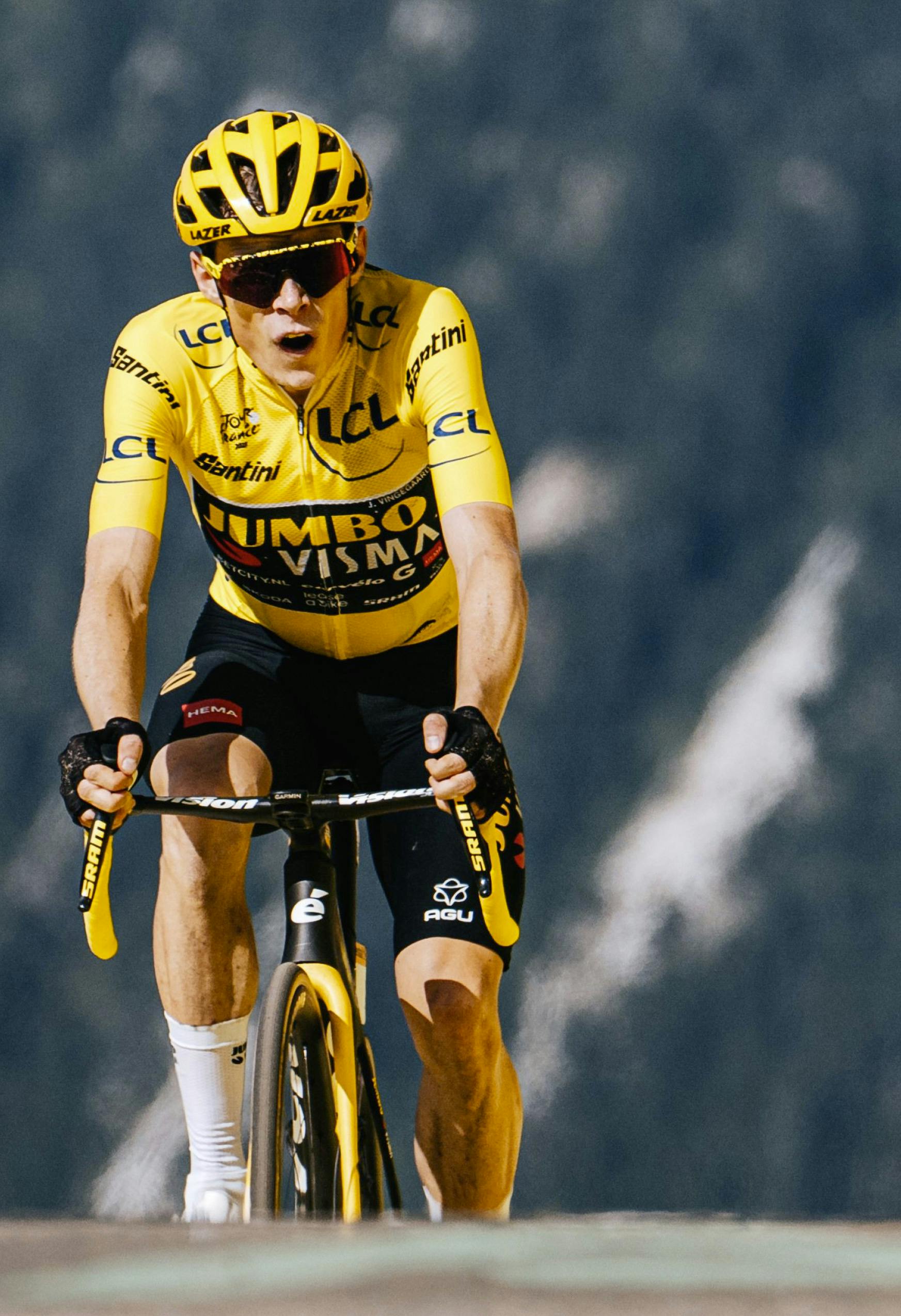 Jonas Vingegaard, wearing the yellow jersey, crests a mountaintop finish on his Cervélo R5.