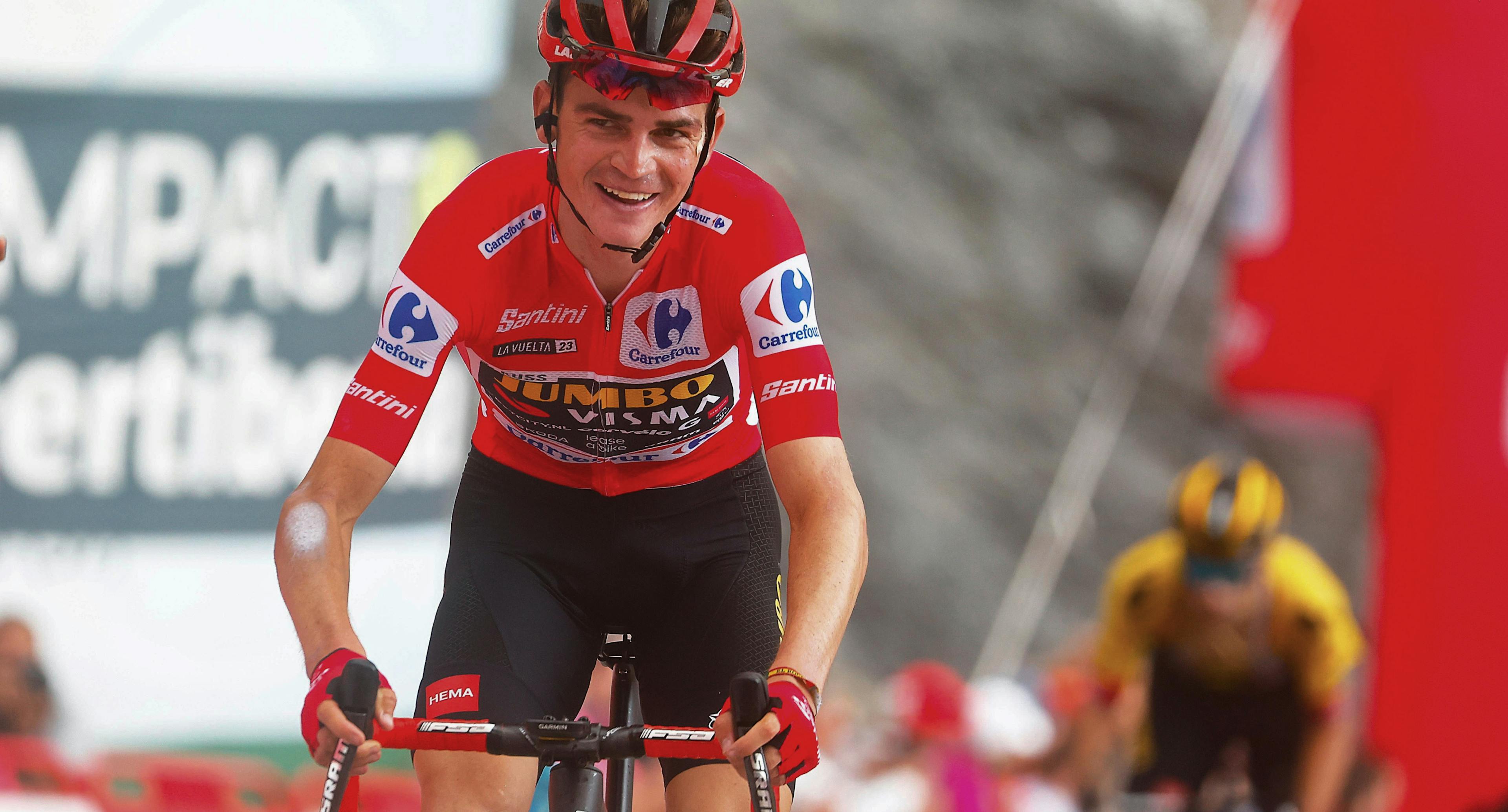 Sepp Kuss smiles while wearing the Red Jersey of the Vuelta a España.