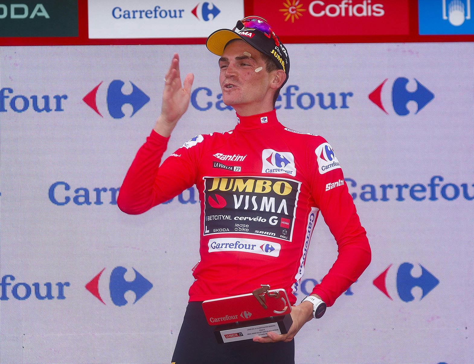 Sepp on the podium wearing the Red Jersey for the first time and blowing a kiss to the crowd.